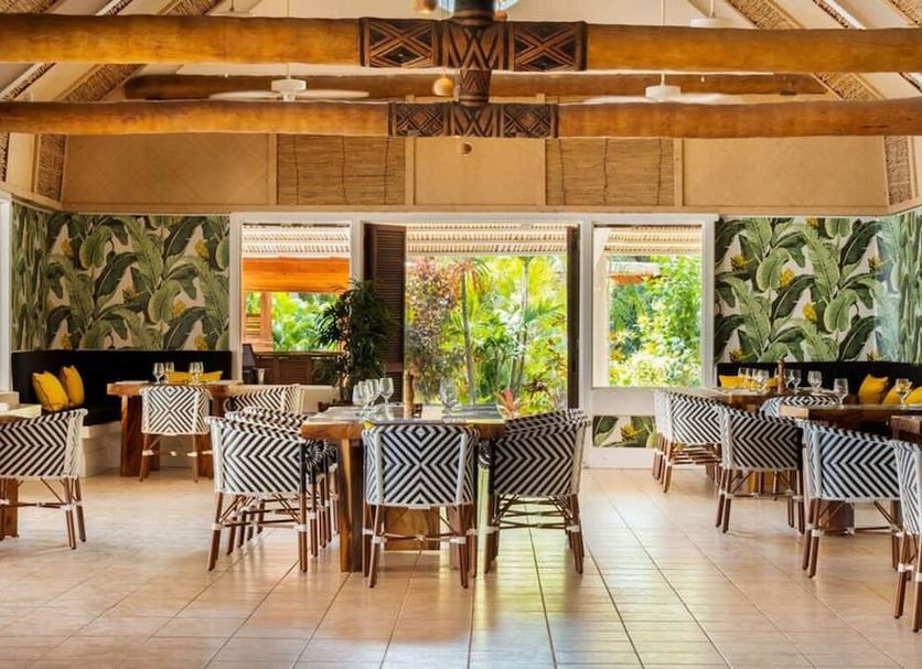 Musket Cove Island Resort and Marina dining room on Malolo Island with tropical garden views and patterned chairs