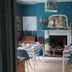 Newberry Beach Lodge, Ilfracombe: colorful dining room with fireplace, tables set for breakfast and teal walls