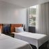 Hampton by Hilton Bogota Usaquen room with two twin beds and city view in Bogotá