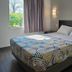Motel 6-Joliet, IL - Chicago - I-55 guest room with bed, window, and wall sconces