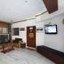 Hotel Ajay International lobby in Agra with seating area, wall TV, and marble floor