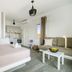 Oniropetra Apartaments in Plintri: bright studio with bed, sofa, kitchenette and window view