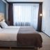 Hotel Bieze Borger guest room with double bed, large window, and wall-mounted TV