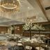 Sheraton Eatontown Hotel ballroom with round banquet tables, white floral centerpieces and chandeliers in Eatontown