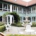 eXo Hotel Franka Bamberg courtyard with fountain, white patio seating and vine-covered arch in Hallstadt
