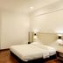 Luna Capsule in Semporna, compact guest room with bed, wall-mounted TV and dark door