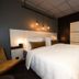 Svalbard Hotell | The Vault guest room in Longyearbyen with a double bed and warm pendant lights
