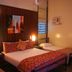 Heritage Lodge in the Daintree, Diwan guest room with double bed, wall art, bedside lamps and air conditioner