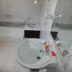 Leinmach House Nyali bathroom with a sink, mirror, tiled walls and a bathtub in Mombasa