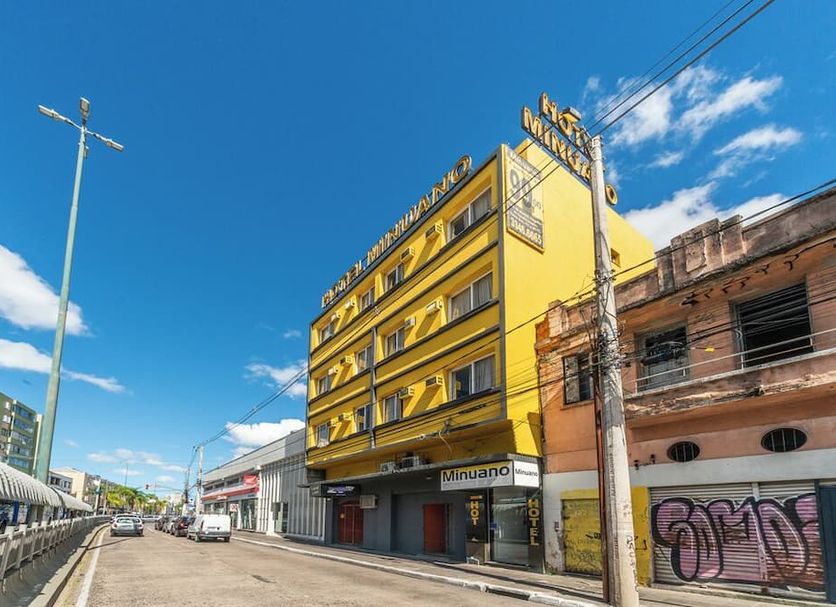 Minuano Hotel Home in Porto Alegre, yellow street-side hotel building on a sunny city avenue