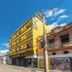 Minuano Hotel Home in Porto Alegre, yellow street-side hotel building on a sunny city avenue