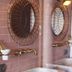 Finca Hotel Rural Es Turó in Ses Salines bathroom with stone sink and round mirrors on pink tile wall