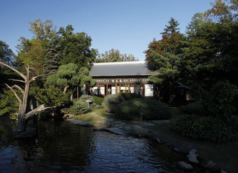 Toyoko Inn Tokachi Obihiro Ekimae in Obihiro beside a garden pond with trees and a traditional-style building