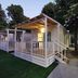 Camping Serenissima in Malcontenta: illuminated cabin-style lodging with porch and steps beside trees