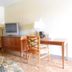 Airport Inn Downtown Phoenix room with TV, desk, mini fridge and dresser