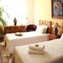 The Mexican Inn in Cabo San Lucas room with two twin beds, bedside lamps, and a framed painting