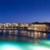 Knossos Beach Bungalows Suites Resort & Spa in Kokkini Hani with illuminated beachfront and pool at night