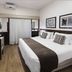 Plaza Blumenau Hotel room in Blumenau with king bed, desk, and wood flooring