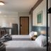 Lym Flat Hotel in Uberlândia guest room with two twin beds and a kitchenette