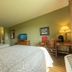 Santa's Lodge in Santa Claus guest room with two beds, desk, TV and lamps