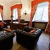 Hotel Chateau Gbelany lounge in Gbelany with tufted sofas, desk, chandeliers and tall windows