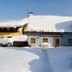 Pension Göschlberger in Mondsee covered in snow with a wintery facade and snowy courtyard