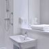Travelodge Burton M6 Northbound bathroom with wall-mounted sink and shower in Carnforth