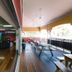 Global Backpackers Cairns Central common area with wooden deck seating and indoor lounge in Cairns