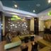 Holiday Inn Christiansburg Blacksburg By IHG lobby with green sofas, patterned chairs and reception desk