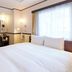 Toyoko Inn Gumma Isesaki Ekimae guest room with bed, desk, TV and large window in Isesaki