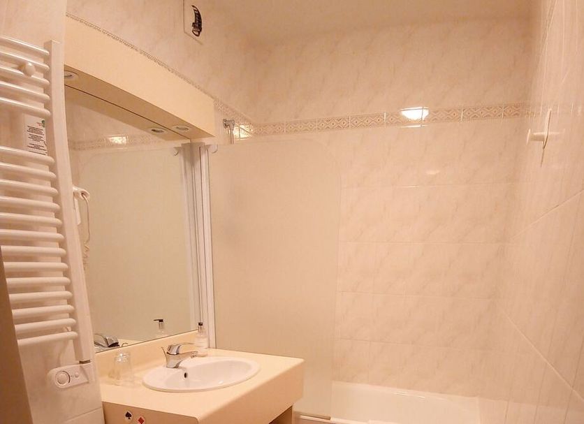 La Sterne in Saint-Gilles-Croix-de-Vie bathroom with sink, mirror, shower and heated towel rail