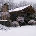 Chalet of Canandaigua in Canandaigua, snowy chalet-style hotel with wood balcony and stone chimney