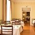 Pousada Palácio de Queluz dining room in Queluz with white-tableclothed tables and polished wood floors