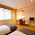 Matsubaya Ryokan Kyoto guest room with twin beds, desk, chairs, and window blinds