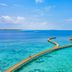 Emerald Faarufushi Resort & Spa in Ifuru with a long overwater walkway to a thatched lagoon pavilion