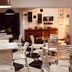 Boutique Hotel Casa Teatro in Manaus dining area with white chairs, tables, and black-and-white tiled floor