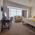 The Coast Yard B & B and Garden Chalets in Chichester with a bed, sofa, and large bay window