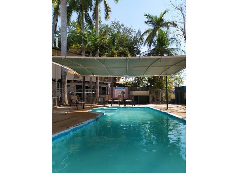 K - Town Hotel in Katherine with outdoor pool and shaded cabana beneath palm trees