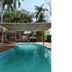 K - Town Hotel in Katherine with outdoor pool and shaded cabana beneath palm trees