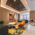 Orange Hotel Beijing Japan Medical University lounge in Beijing with colorful chairs and patterned carpet