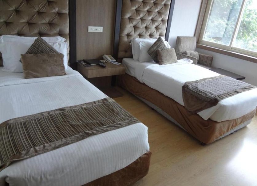 Hotel Airport Centre Point Nagpur twin guest room with two single beds and a window view