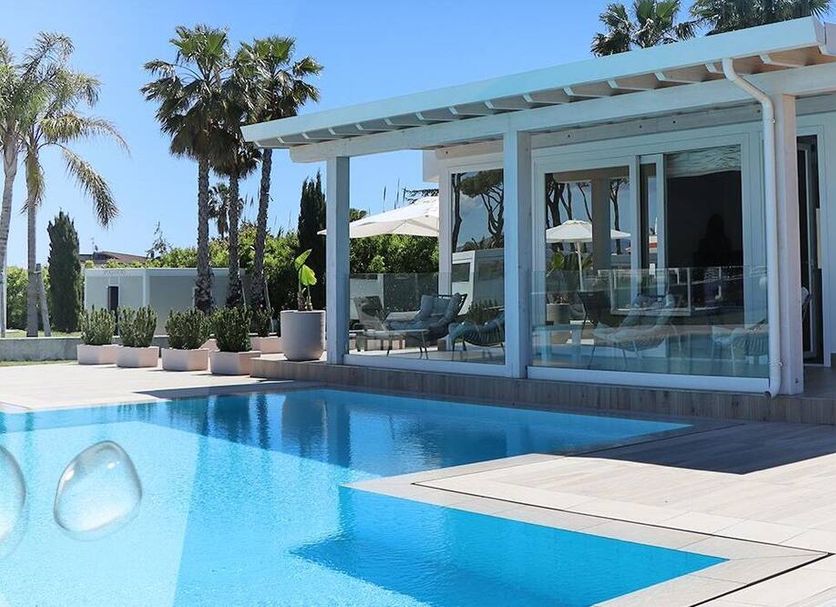 Female Resort in San Felice Circeo with outdoor pool and modern glass-walled terrace