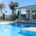Female Resort in San Felice Circeo with outdoor pool and modern glass-walled terrace