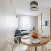 Appart'City Classic Reims Parc des Expositions apartment with dining table, sofa, and bedroom view