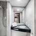 B&b Hotel Hannover-Laatzen bathroom with shower, sink and mirror in Laatzen