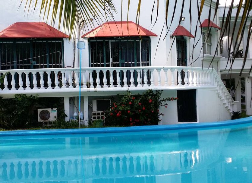 Mansion Giahn Bed & Breakfast in Cancún with poolfront balconies and red-roofed windows