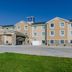 Cobblestone Hotel & Suites - Mccook exterior in McCook with parking lot and blue sky