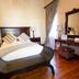 Old House Lodge Beaufort West guest room with double bed, wooden floor and ornate mirror
