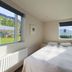 Seydisfjördur Guesthouse room in Seydisfjordur with double bed, bunk bed, and mountain views