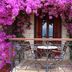 Ilion Hotel in Nafpaktos balcony framed by purple bougainvillea with sea view